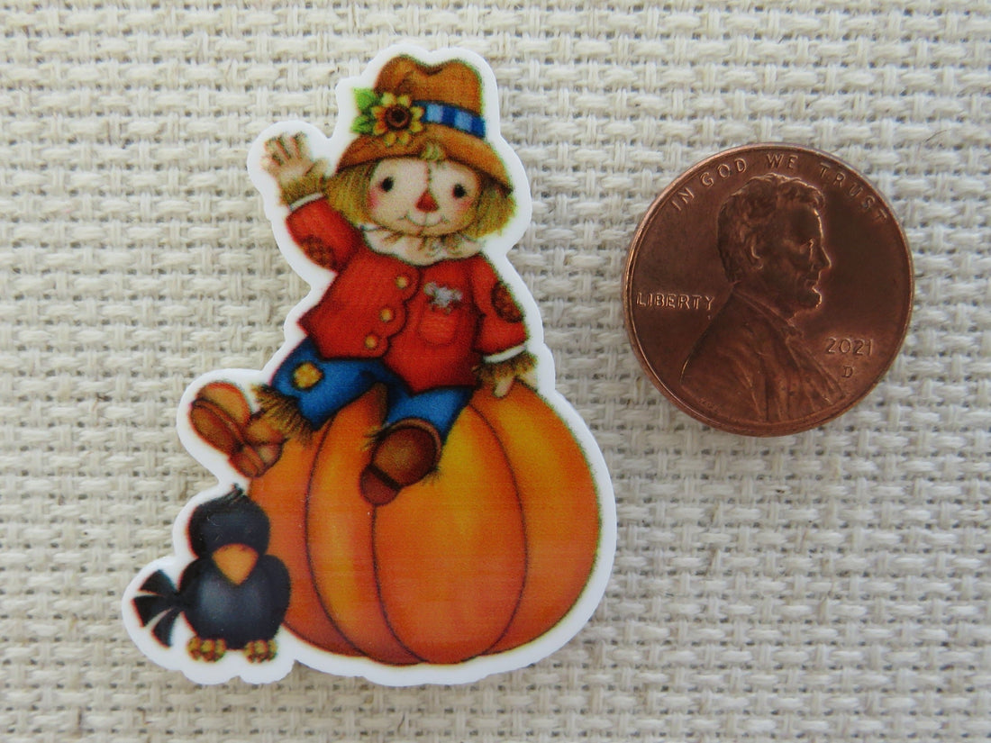 First view of Scarecrow Sitting on Top of a Pumpkin with a Crow Friend Needle Minder.