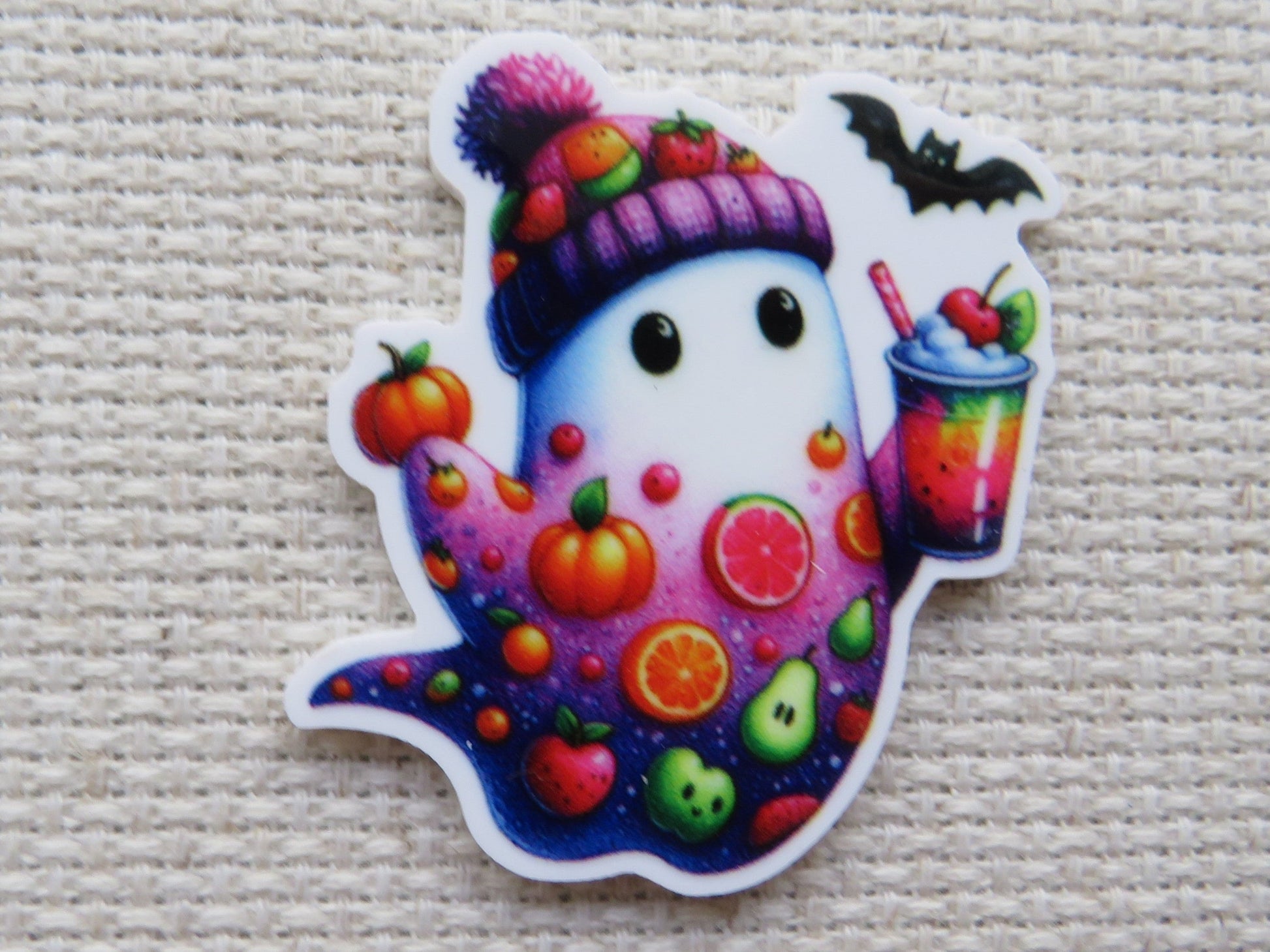 First view of White and purple ghost with fruit slices, a pumpkin, tomato, apple, an avocado...just to name a few and he is holding a cool looking drink minder.