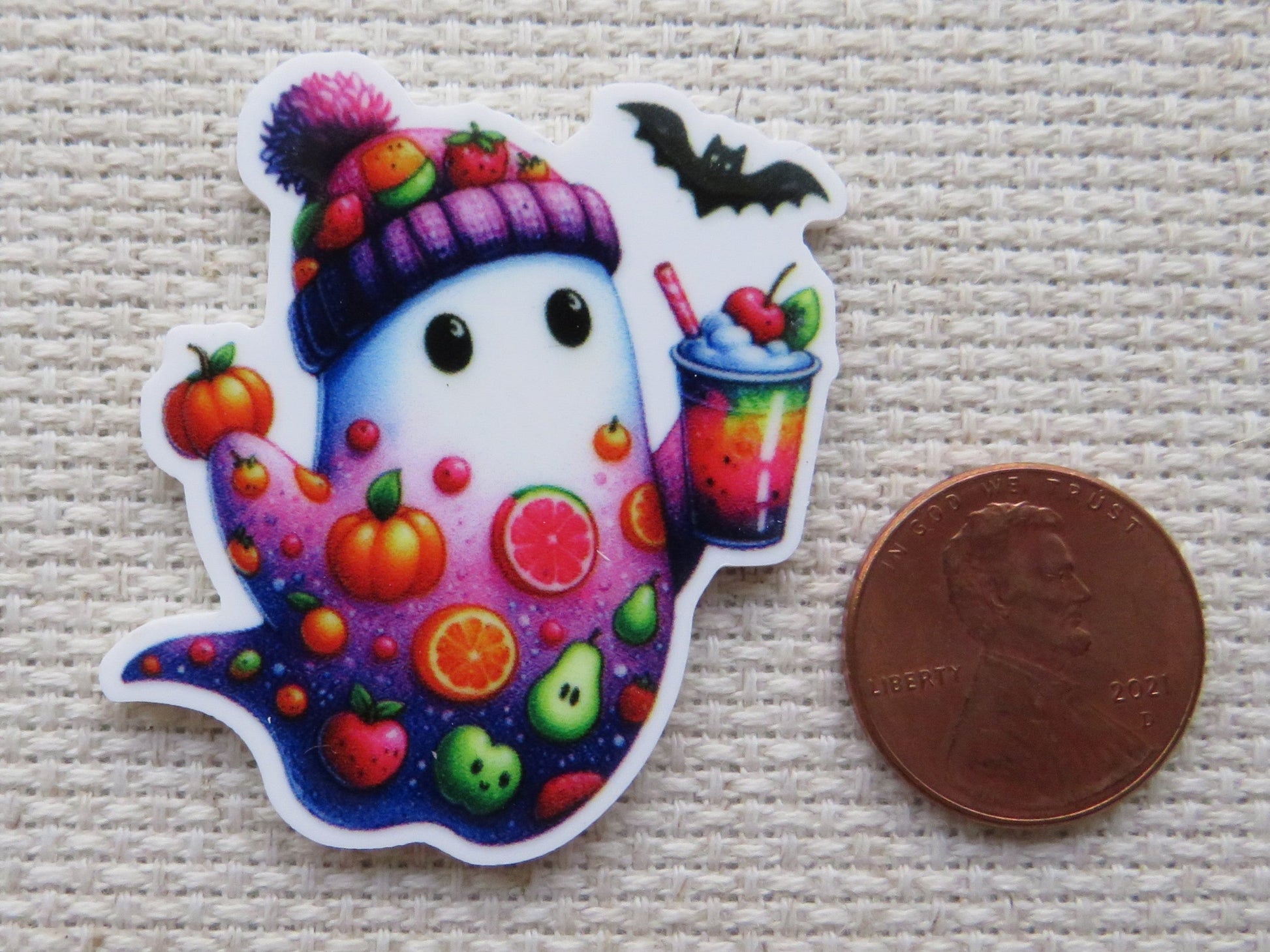 Second view of White and purple ghost with fruit slices, a pumpkin, tomato, apple, an avocado...just to name a few and he is holding a cool looking drink minder.