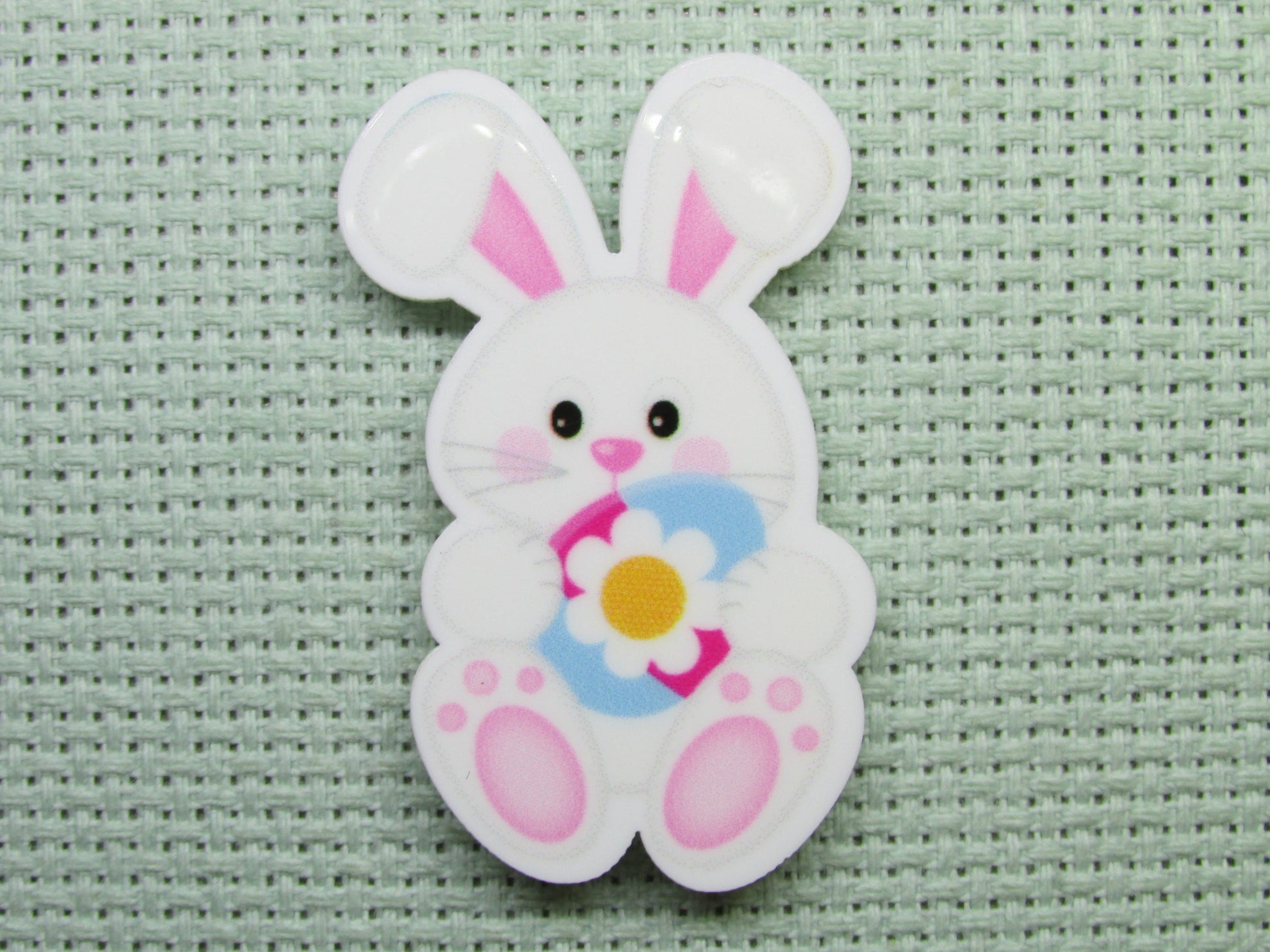 First view of the Easter Bunny Holding a Pretty Flower Easter Egg Needle Minder