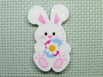 First view of the Easter Bunny Holding a Pretty Flower Easter Egg Needle Minder