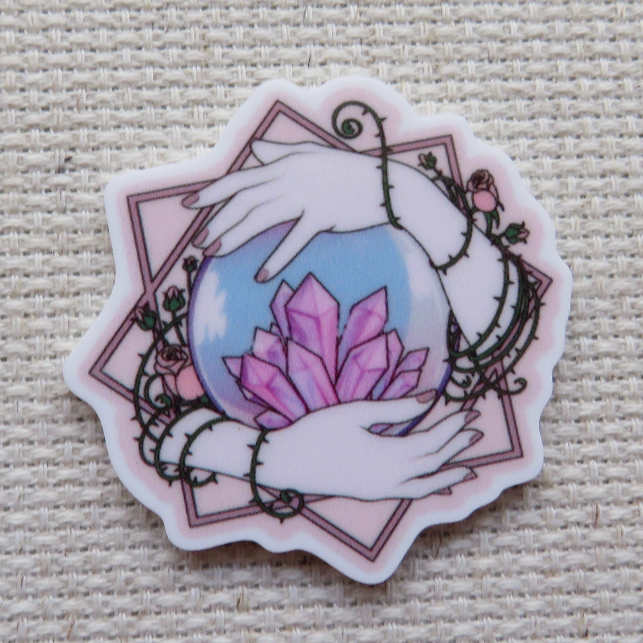 First view of Hands Holding a Crystal Ball Needle Minder.