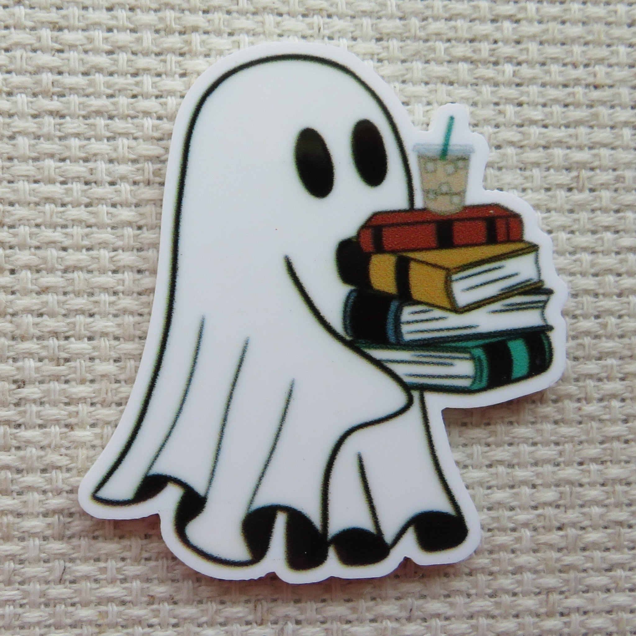 First  view of a ghost carrying a stack of books with a drink on top minder.